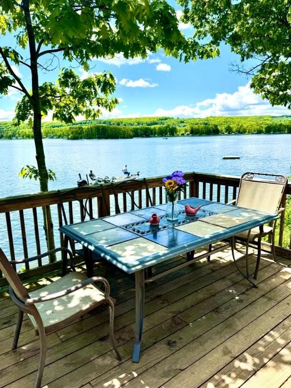 450 Stover Rd, Tyrone, NY 14815 - wooden terrace with a water view and outdoor dining space