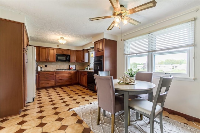 63 Shadywood Dr, Gates, NY 14606 - dining room with ceiling fan, light flooring, and baseboards