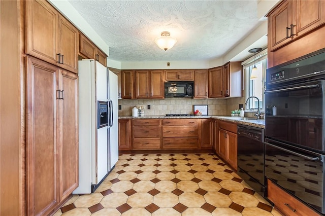 63 Shadywood Dr, Gates, NY 14606 - kitchen with black appliances, a sink, light flooring, brown cabinetry, and a textured ceiling