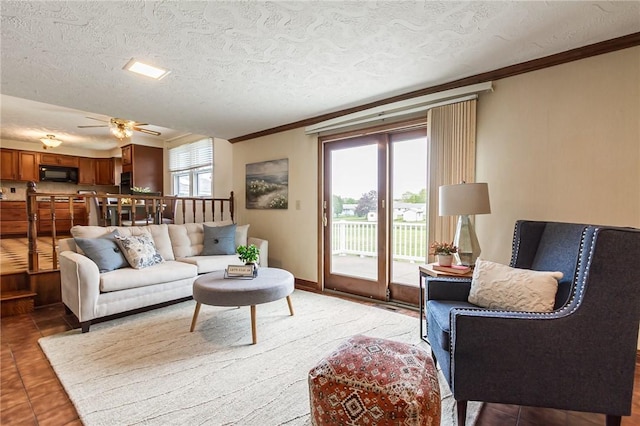 63 Shadywood Dr, Gates, NY 14606 - living room featuring crown molding, ceiling fan, light tile patterned flooring, and a textured ceiling