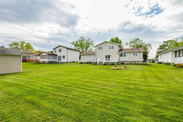 63 Shadywood Dr, Gates, NY 14606 - rear view of property featuring a lawn, a residential view, and a wooden deck