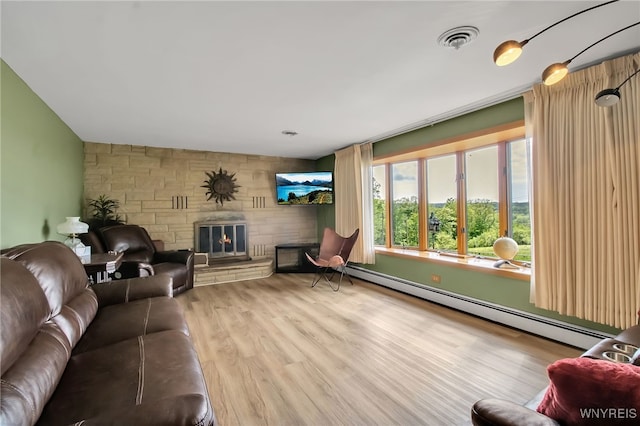 3955 Four Rod Rd Unit S, Marilla, NY 14052 - living area with a baseboard heating unit, wood finished floors, and a fireplace