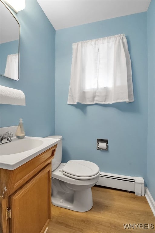 3955 Four Rod Rd Unit S, Marilla, NY 14052 - bathroom featuring a baseboard radiator, toilet, vanity, and wood finished floors
