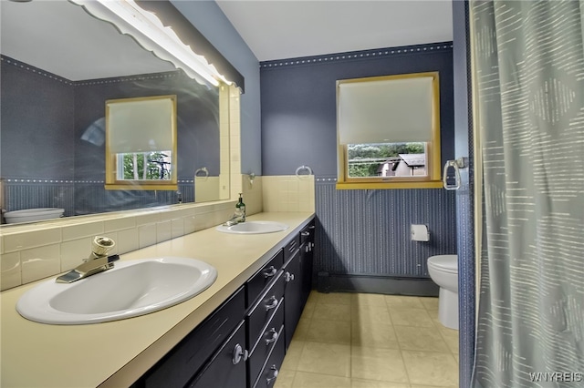3955 Four Rod Rd Unit S, Marilla, NY 14052 - full bathroom with toilet, double vanity, tile patterned floors, and wainscoting
