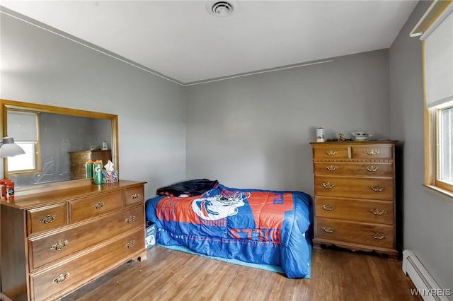3955 Four Rod Rd Unit S, Marilla, NY 14052 - bedroom with a baseboard heating unit and wood finished floors