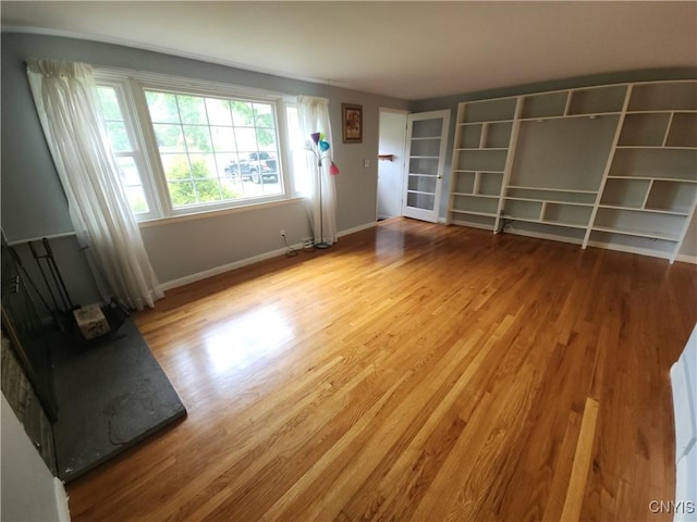 149 Robbins Ln, Dewitt, NY 13214 - unfurnished living room featuring wood finished floors and baseboards
