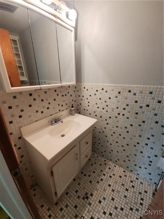 149 Robbins Ln, Dewitt, NY 13214 - bathroom with tile walls, vanity, and a wainscoted wall