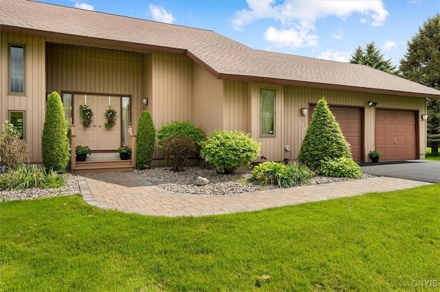 5 Byron Ln, Kirkland, NY 13323 - view of front of property with an attached garage, a front yard, asphalt driveway, roof with shingles, and entry steps
