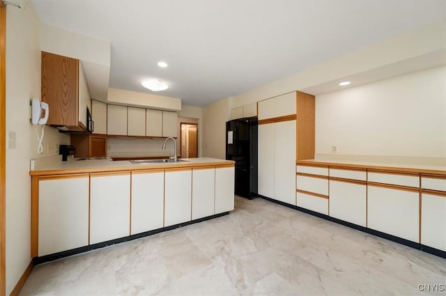 5 Byron Ln, Kirkland, NY 13323 - kitchen with a sink, freestanding refrigerator, light marble finish flooring, a peninsula, and light countertops