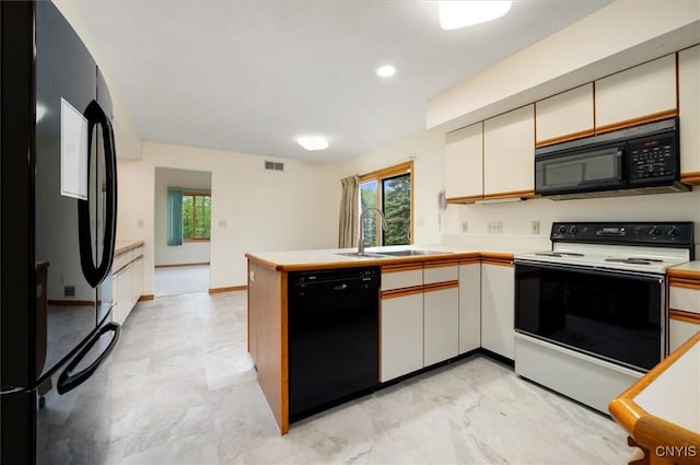 5 Byron Ln, Kirkland, NY 13323 - kitchen with black appliances, a sink, a peninsula, light countertops, and white cabinetry
