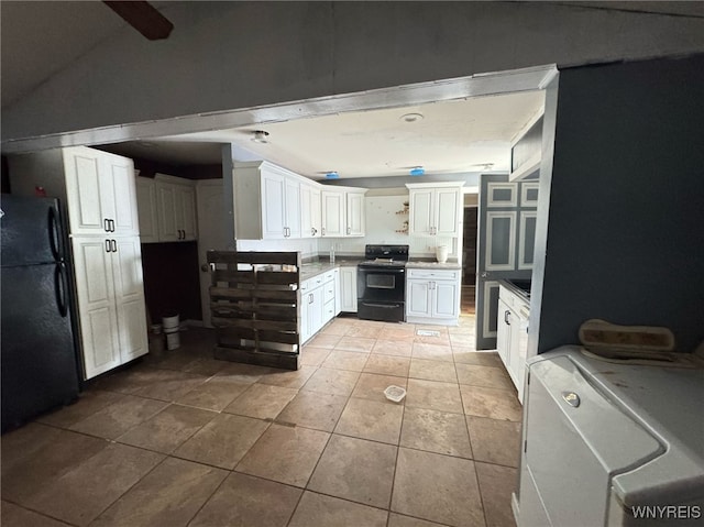 7 High St, Lyons, NY 14489 - kitchen with black appliances, light tile patterned floors, white cabinets, and lofted ceiling