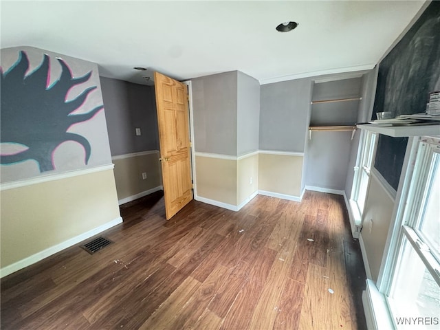 7 High St, Lyons, NY 14489 - unfurnished bedroom with wood finished floors, baseboards, and a closet