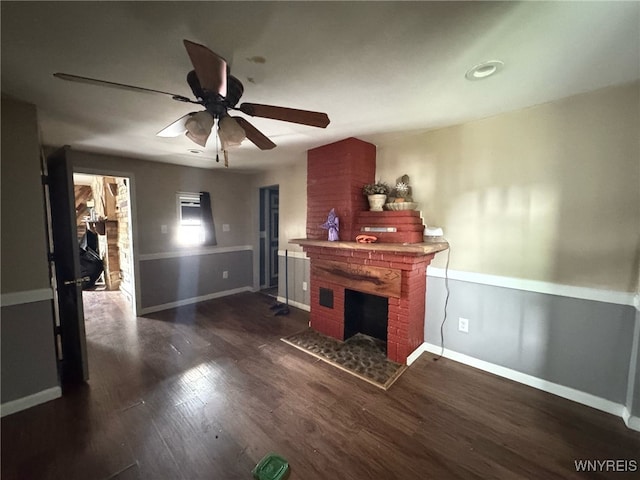 7 High St, Lyons, NY 14489 - living room featuring a fireplace, a ceiling fan, baseboards, and dark wood-style floors