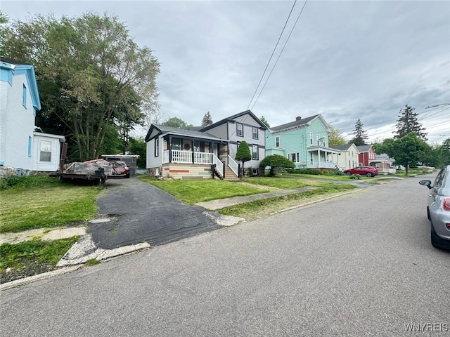 7 High St, Lyons, NY 14489 - view of front facade featuring a porch, a residential view, and a front yard