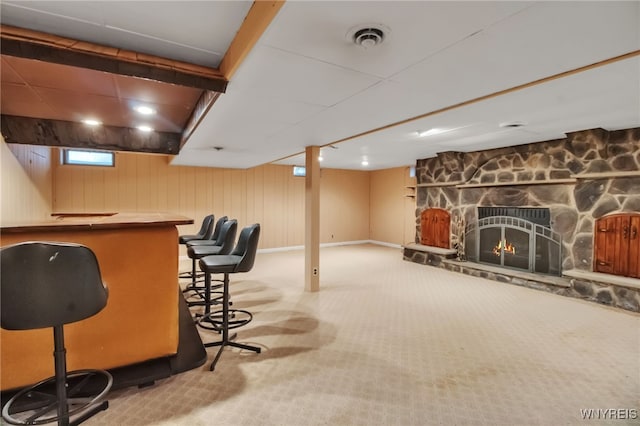 69 Coolidge Ave, Lockport-City, NY 14094 - indoor dry bar featuring carpet, a stone fireplace, and baseboards