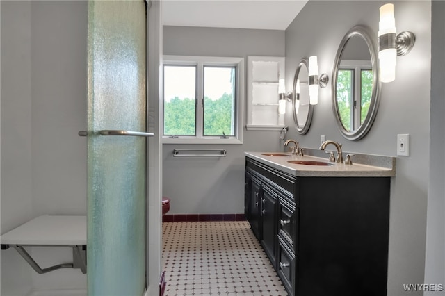 69 Coolidge Ave, Lockport-City, NY 14094 - full bath featuring double vanity, tile patterned floors, toilet, and a shower with shower door
