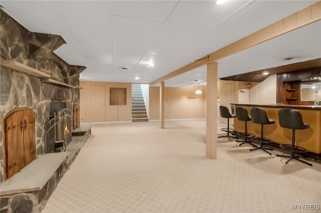 69 Coolidge Ave, Lockport-City, NY 14094 - finished below grade area with light carpet, a stone fireplace, stairway, and bar