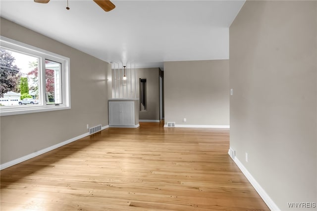 69 Coolidge Ave, Lockport-City, NY 14094 - unfurnished living room with a ceiling fan, light wood-style flooring, and baseboards