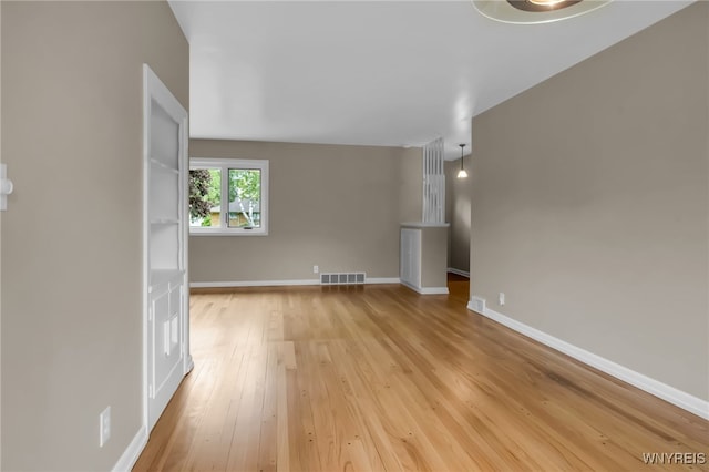 69 Coolidge Ave, Lockport-City, NY 14094 - unfurnished living room with light wood-style flooring and baseboards
