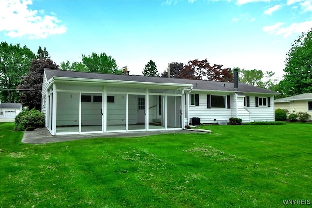 69 Coolidge Ave, Lockport-City, NY 14094 - rear view of house featuring a chimney, a lawn, a sunroom, central air condition unit, and a patio area