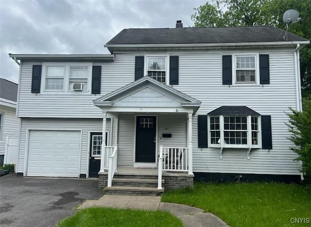2817 Brighton Pl, Utica, NY 13501 - view of front of home featuring a garage, covered porch, asphalt driveway, a chimney, and cooling unit