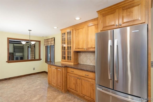 23 Bittersweet Ln, Orchard Park, NY 14127 - kitchen featuring freestanding refrigerator, a chandelier, decorative backsplash, baseboards, and glass insert cabinets