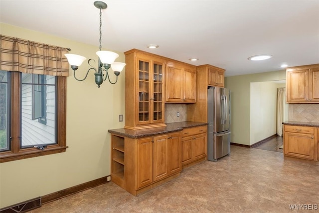 23 Bittersweet Ln, Orchard Park, NY 14127 - kitchen with freestanding refrigerator, tasteful backsplash, baseboards, glass insert cabinets, and recessed lighting