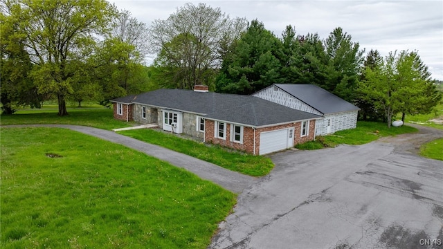 4335 US Route 11, Richland, NY 13142 - ranch-style home with asphalt driveway, a garage, a front lawn, and a chimney