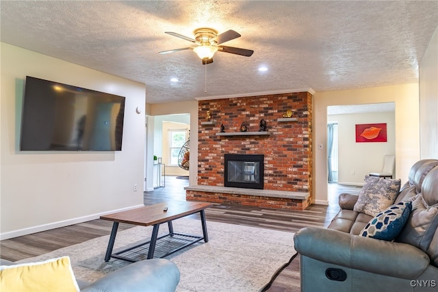 4335 US Route 11, Richland, NY 13142 - living room with wood finished floors, ceiling fan, a textured ceiling, a brick fireplace, and baseboards