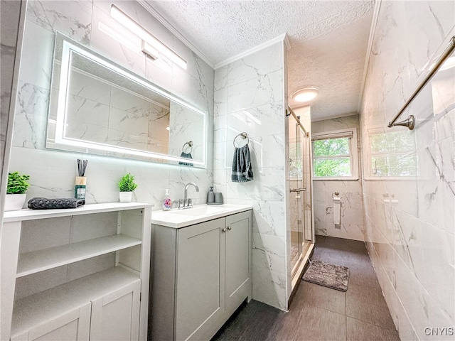 4335 US Route 11, Richland, NY 13142 - bathroom featuring a textured ceiling, a marble finish shower, vanity, ornamental molding, and tile walls