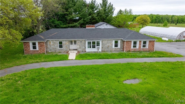 4335 US Route 11, Richland, NY 13142 - ranch-style house featuring a front yard, a chimney, stone siding, and roof with shingles