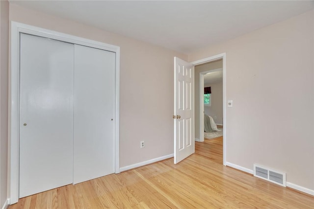 1 Ashton Dr, Gates, NY 14624 - unfurnished bedroom featuring light wood-type flooring, baseboards, and a closet