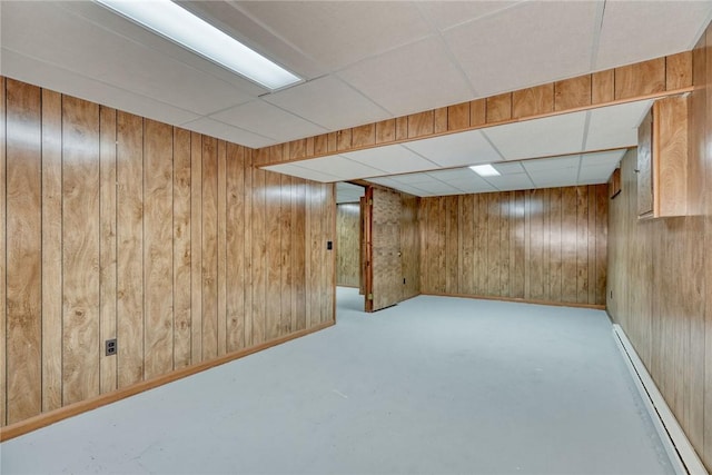 1 Ashton Dr, Gates, NY 14624 - finished below grade area featuring baseboard heating, a drop ceiling, and wood walls