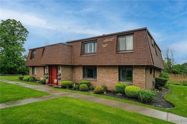 3898 Ridge Lea Rd Unit B, Amherst, NY 14228 - view of front of house with brick siding, mansard roof, and a front lawn