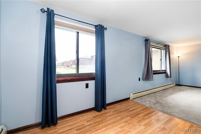 3898 Ridge Lea Rd Unit B, Amherst, NY 14228 - unfurnished room with baseboard heating, light wood-style flooring, and plenty of natural light