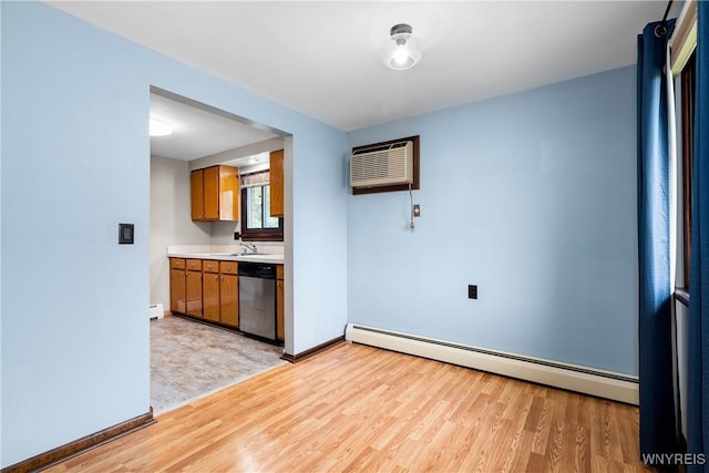 3898 Ridge Lea Rd Unit B, Amherst, NY 14228 - kitchen featuring dishwasher, a baseboard heating unit, light wood-style floors, a wall unit AC, and light countertops