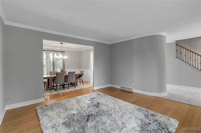 110 Hunt Club Cir, Amherst, NY 14051 - living room with wood finished floors, stairs, ornamental molding, baseboards, and a chandelier