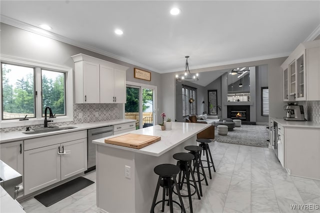 110 Hunt Club Cir, Amherst, NY 14051 - kitchen featuring a sink, stainless steel dishwasher, light marble finish floors, a center island, and tasteful backsplash