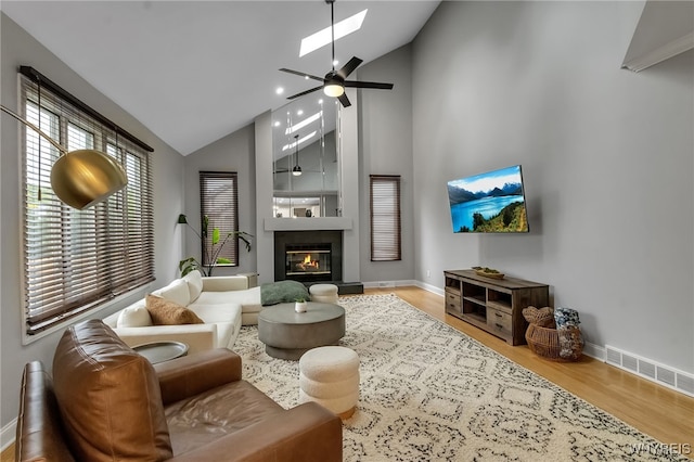 110 Hunt Club Cir, Amherst, NY 14051 - living area featuring a skylight, wood finished floors, baseboards, a ceiling fan, and high vaulted ceiling