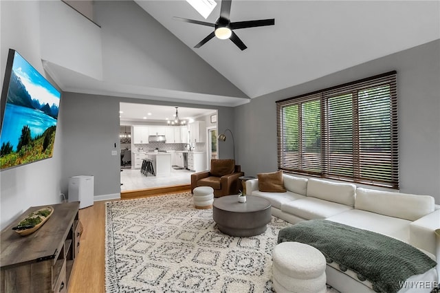 110 Hunt Club Cir, Amherst, NY 14051 - living area featuring a chandelier, ceiling fan, light wood-style floors, and high vaulted ceiling