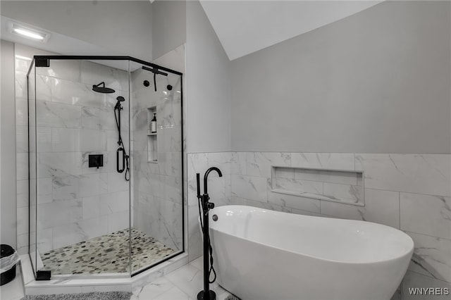 110 Hunt Club Cir, Amherst, NY 14051 - bathroom with a freestanding bath, marble look tile flooring, tile walls, a shower stall, and lofted ceiling