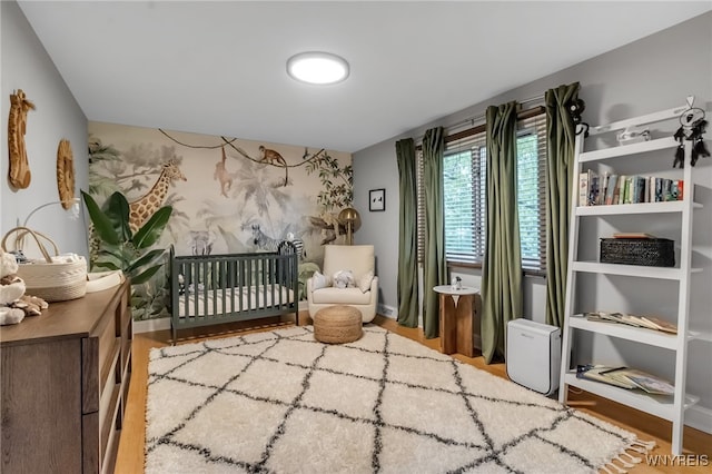 110 Hunt Club Cir, Amherst, NY 14051 - bedroom featuring wood finished floors and a nursery area