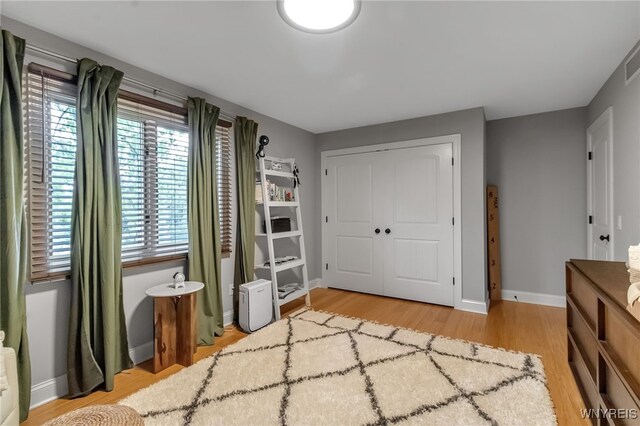 110 Hunt Club Cir, Amherst, NY 14051 - bedroom featuring light wood-type flooring, a closet, and baseboards