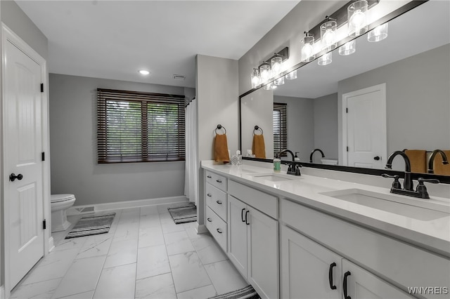 110 Hunt Club Cir, Amherst, NY 14051 - bathroom featuring double vanity, toilet, marble finish floors, recessed lighting, and baseboards