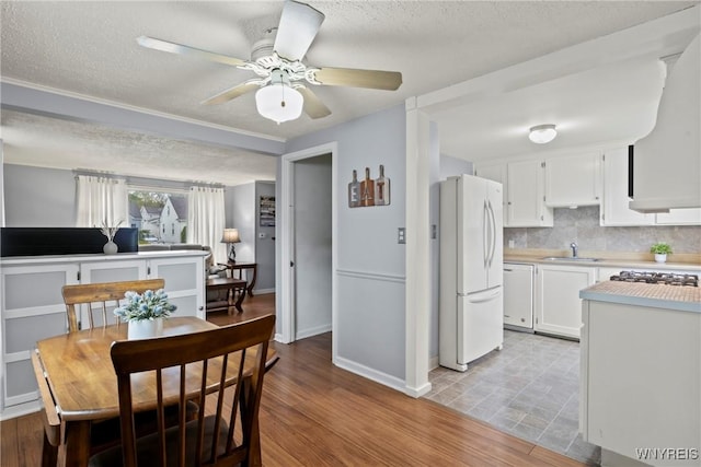 234 Clark St, Tonawanda-Town, NY 14223 - dining space featuring a textured ceiling, ceiling fan, light wood-style flooring, and baseboards