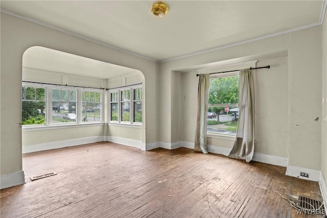 22 Bruce St, Buffalo, NY 14214 - spare room with ornamental molding, hardwood / wood-style floors, baseboards, and arched walkways