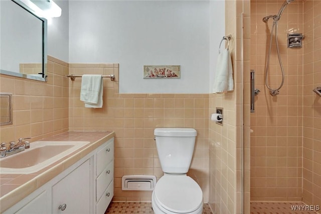 149 Fleetwood Ter, Amherst, NY 14221 - bathroom featuring a stall shower, tile walls, vanity, toilet, and a wainscoted wall