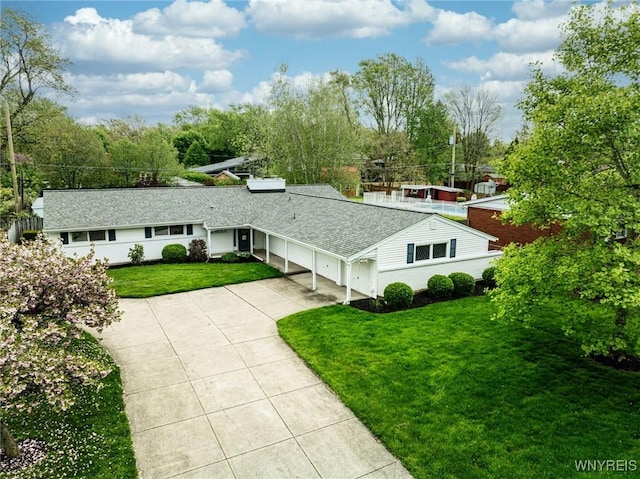 149 Fleetwood Ter, Amherst, NY 14221 - view of front of home with driveway, a front yard, an attached garage, and a shingled roof