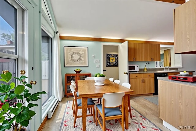 149 Fleetwood Ter, Amherst, NY 14221 - dining room with light wood-style floors and a baseboard heating unit