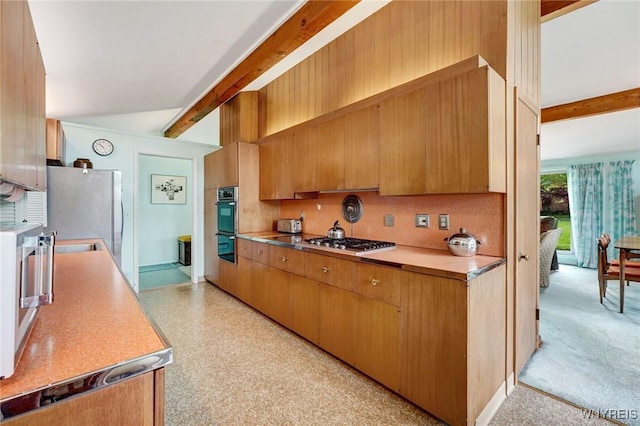 149 Fleetwood Ter, Amherst, NY 14221 - kitchen with beamed ceiling, appliances with stainless steel finishes, light countertops, and brown cabinetry